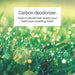 Close-up of grass with a drop of water, featuring text about a carbon deodorizer.